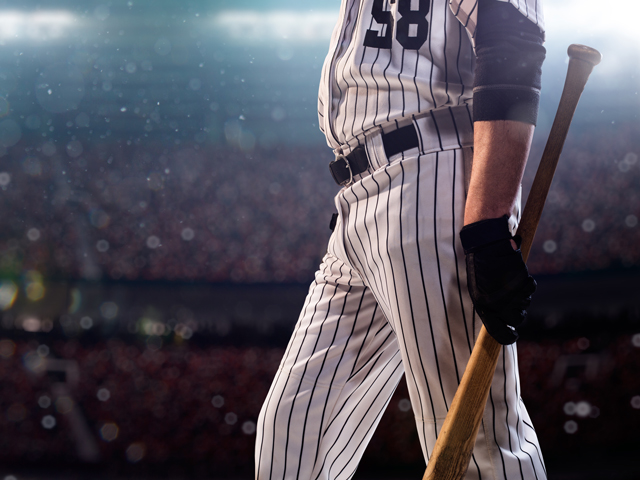 A baseball player walking up to bat listening to the walk up song he chose