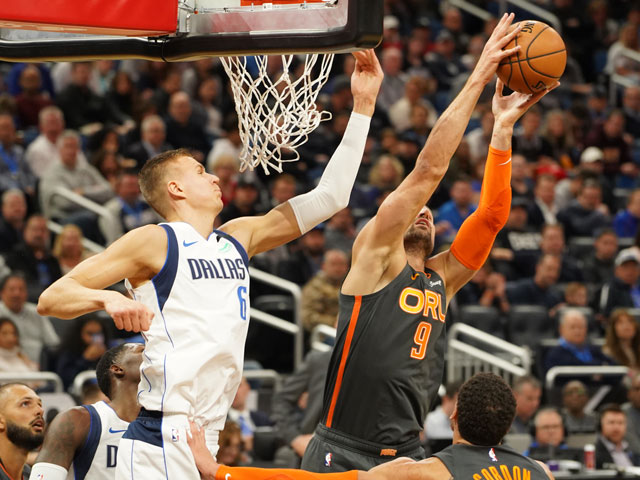 NBA player rebounding the ball on his way to a Triple-Double