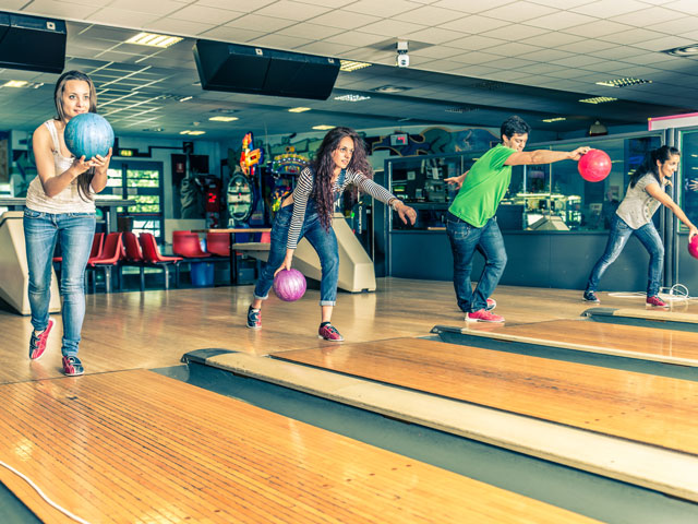 Friends Bowling in a Bowling Alley