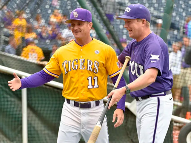 Two college coaches discussing hitting fungos with a fungo bat